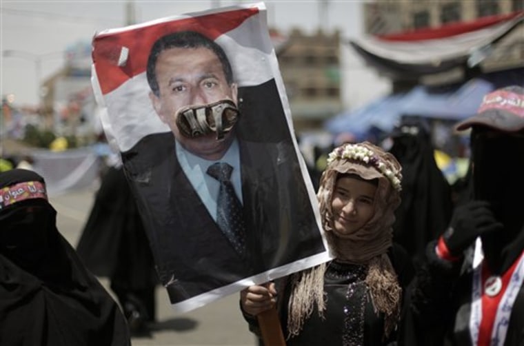 A female anti-government protester holds up a poster of Yemeni President Ali Abdullah Saleh with a shoe stuck onto it, a symbolic cultural insult, during a demonstration demanding the resignation of President Saleh, in Sanaa, Yemen, on Sunday, April 17. Yemen's anti-government movement took up the issue of women's rights in the conservative Muslim nation on Saturday, as thousands of demonstrators seeking the ousting of the president denounced his comments against the participation of women in protest rallies. 